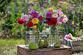 Bouquets of roses (Rosa), dahlias (Dahlia), wild carrot, autumn anemone (Anemone Japonica) with pears in a wire basket