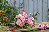 Bouquet of roses (Rosa), gladioli (Gladiolus), fennel blossoms, asparagus, rose hips, autumn anemone, onion blossom