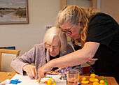 Care home resident taking part in activity