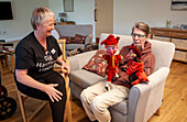 Care home resident with puppets