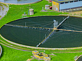 Aerial view of sewage farm on bank of flooded River Avon, UK