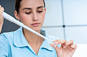 Scientist pipetting into cuvette