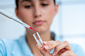 Scientist pipetting into cuvette