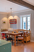 Dining area with wooden table, chairs and rustic country-style bench seat