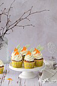 Carrot cupcakes with cream cheese cream and candied orange peel