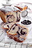 Yeast plait with blueberry filling and icing sugar