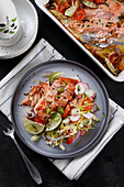Oven-baked salmon fillet with radish salad and lime