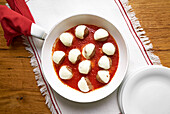 Meatballs with mozzarella on tomato sauce