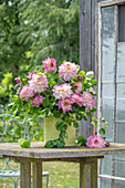 Bouquet of dahlias (Dahlia) and summer lime on garden table