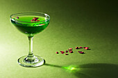 Green gin cocktail with dried rose petals