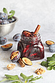 Plum jam with walnuts and cinnamon stick