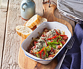 Baked sausage with pepper and blue cheese