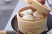Guabao bread in a steamer basket