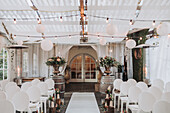 Decorated ceremony hall with lanterns and floral decorations for a wedding