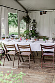 Festively laid tables in the garden pavilion for an event