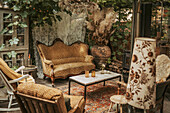 Rustic seating area in the garden shed with vintage furniture and plants