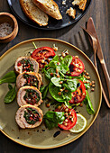 Stuffed pork fillet rolls with spinach, tomatoes and pine nuts