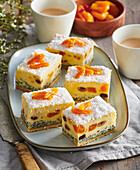 Poppy seed cake slices with candied fruit and grated coconut