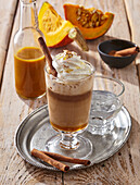 Pumpkin spice latte with whipped cream and cinnamon stick