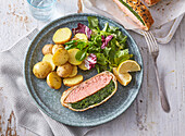 Salmon Wellington with spinach filling, boiled potatoes and leaf salad
