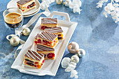 Layer cake with dried fruit and nuts, glaze and chocolate strips