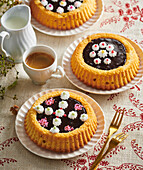 Sponge tartlets with chocolate filling and dots of cream