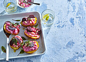 Potato halves with beetroot cream, beans and dill