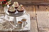 Gluten-free chocolate cupcakes with whipped cream topping and colourful sugar sprinkles