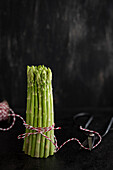 Bundle of green asparagus with kitchen twine