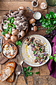 Creamy mushroom soup with fresh herbs and bread