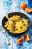 Chicken thighs with orange and olive sauce and couscous