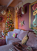 Living room decorated for Christmas with decorated tree and stars