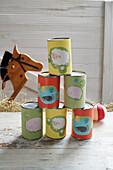 Colourfully decorated tin cans for can throwing