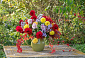 Bouquet of dahlias (Dahlia), asters (Aster), wild vine and rose hips