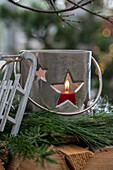 Candle lantern on woodpile, (close-up)