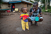 Father and daughter brushing their teeth, Kenya