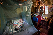 Child sleeping in mosquito net, Kenya