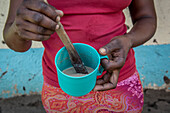 Woman mixing porridge, Kenya