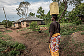 Women carrying water on her head, Kenya