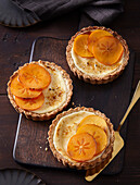 Persimmon cream tartlets with hazelnuts and oat flakes