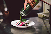 chef adding dressing, Salad, marinated beetroot, chioggia beets, white goat cheese, samphire
