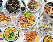Birdseye view, lunch table, salad, fish, oysters, muscles, fries, fried fish, poke bowl