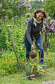 Woman pricking out Ranunculus acris