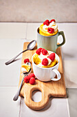 Mug cakes with raspberries and cream topping