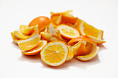 Orange sections and peels on a white background