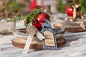 Rustic Advent table decoration with deer, tree disc, fir branches, felt card and apple