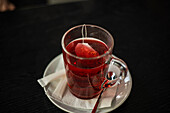 Cup of hibiscus tea on a wooden table
