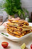Lamb quesadillas with lime wedges and dip