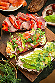Wholemeal sourdough bread with avocado, cold cuts and vegetables