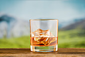 Whisky on the Rocks in front of a mountain backdrop